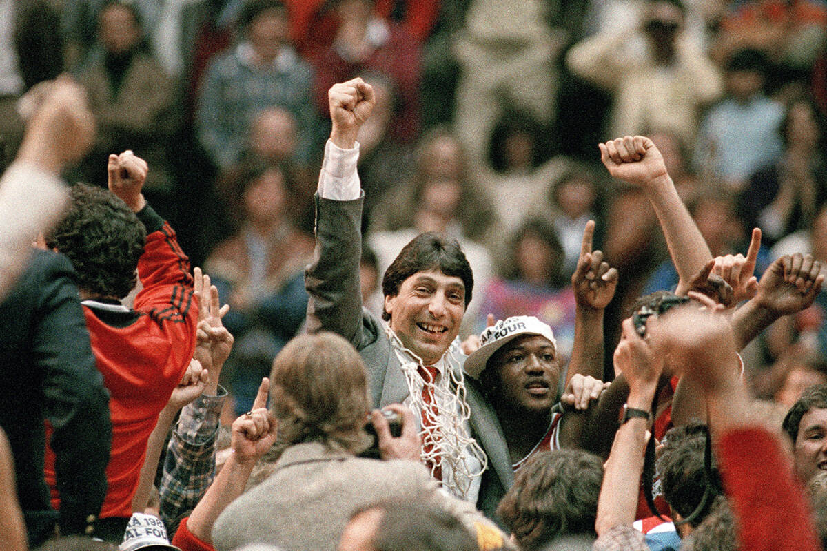 FILE - North Carolina State coach Jim Valvano, center with fist raised, celebrates after the te ...