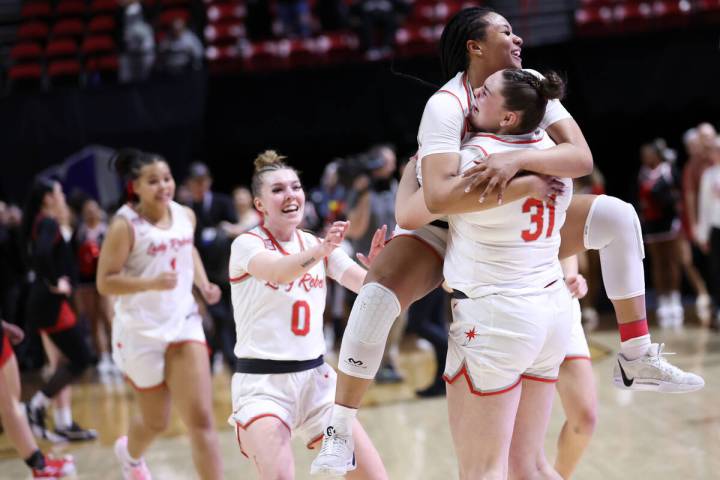 UNLV Lady Rebels forward Alyssa Brown jumps into the arms of center Erica Collins (31) as their ...
