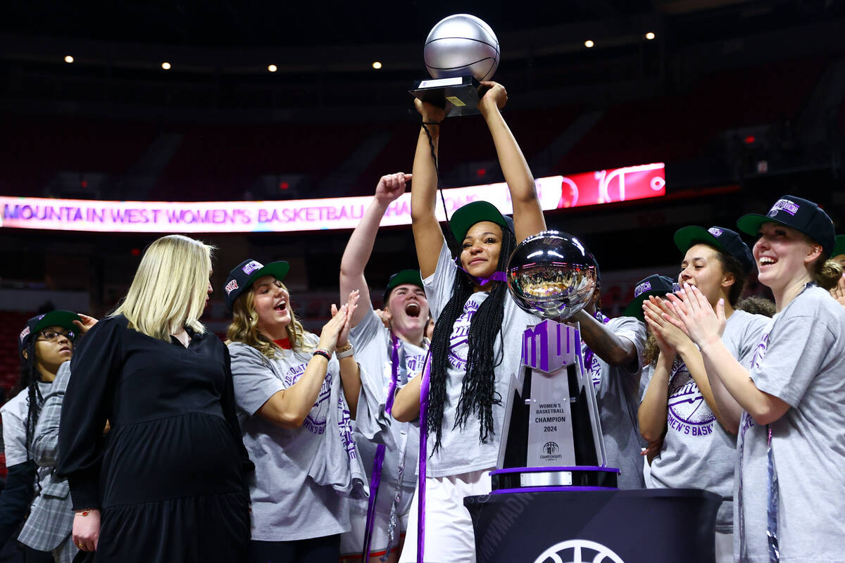 UNLV Lady Rebels forward Alyssa Brown holds up her most valuable player trophy after her team w ...