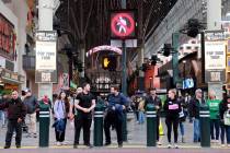 Pedestrians cross 4th Street at Fremont street in downtown Las Vegas Friday, March 15, 2024. An ...