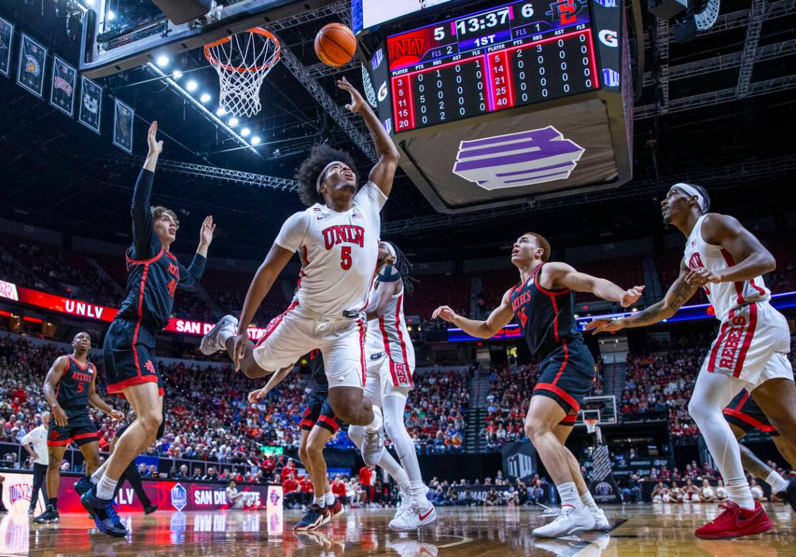 UNLV Rebels forward Rob Whaley Jr. (5) gets off a shot under the basket past San Diego State Az ...