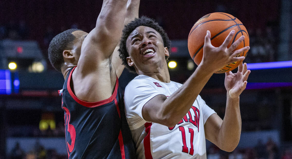 UNLV Rebels guard Dedan Thomas Jr. (11) looks to shoot around San Diego State Aztecs forward Ja ...