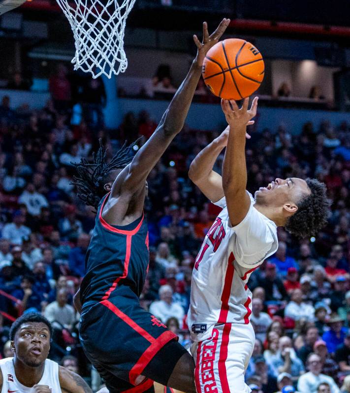 UNLV Rebels guard Dedan Thomas Jr. (11) battles to get off a shot in regulation time against Sa ...