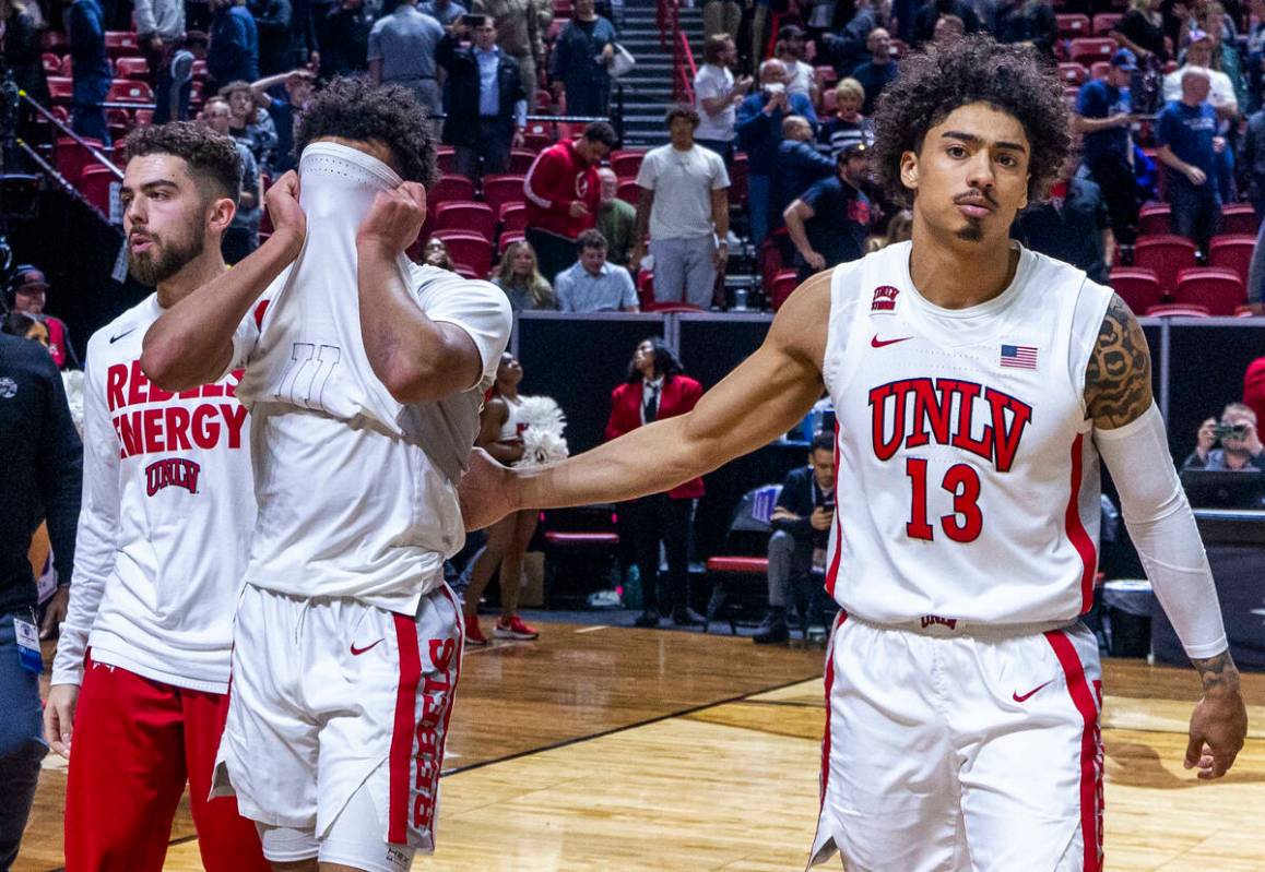 UNLV Rebels guard Dedan Thomas Jr. (11) is dejected while being escorted off the court by teamm ...