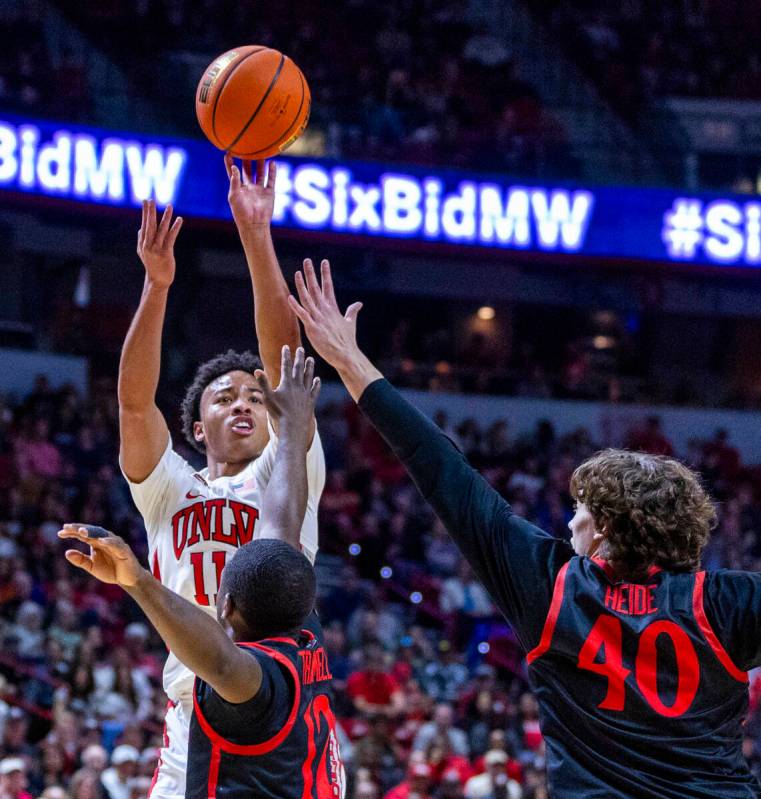 UNLV Rebels guard Dedan Thomas Jr. (11) posts up for a shot over San Diego State Aztecs guard D ...