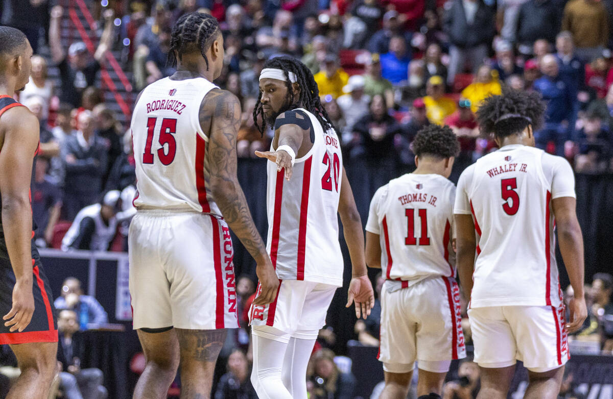 UNLV Rebels forward Keylan Boone (20) looks to keep teammate guard Luis Rodriguez (15) in the g ...