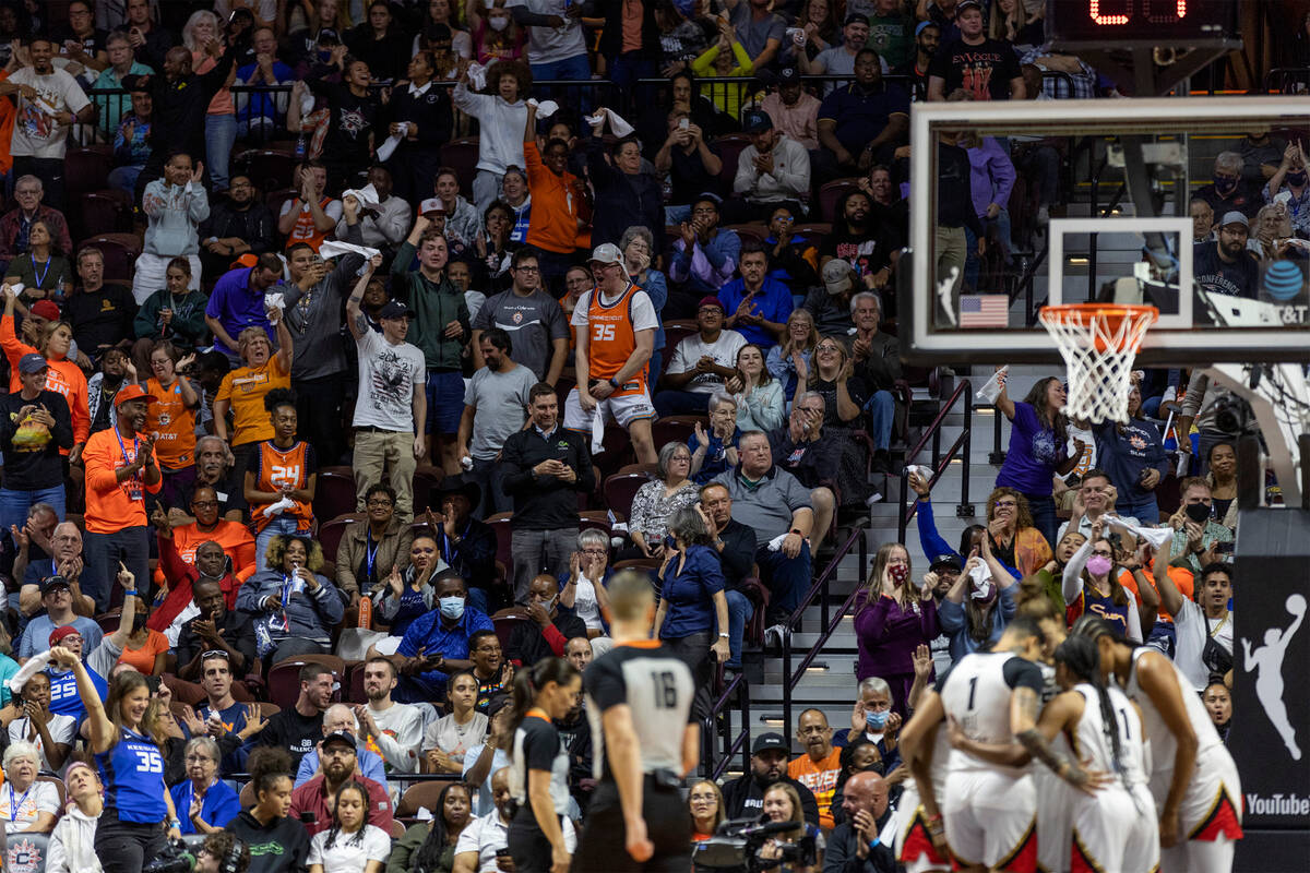 The Connecticut Sun crowd goes wild while the Las Vegas Aces huddle during the second half in G ...