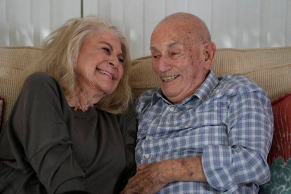 World War II veteran Harold Terens, 100, right, and Jeanne Swerlin, 96, share a laugh as they s ...