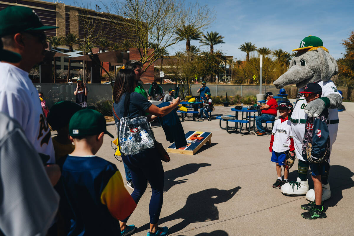 Oakland A’s mascot Stomper poses for photographs with fans during a Big League Weekend g ...