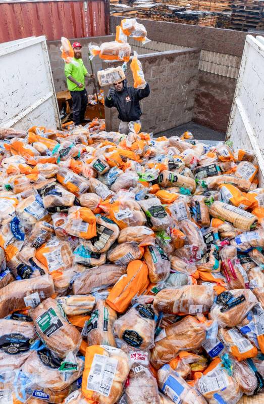 Ken Fick, near, and Chris Arnold with Logistical Solutions remove hundreds of bags of bread dum ...