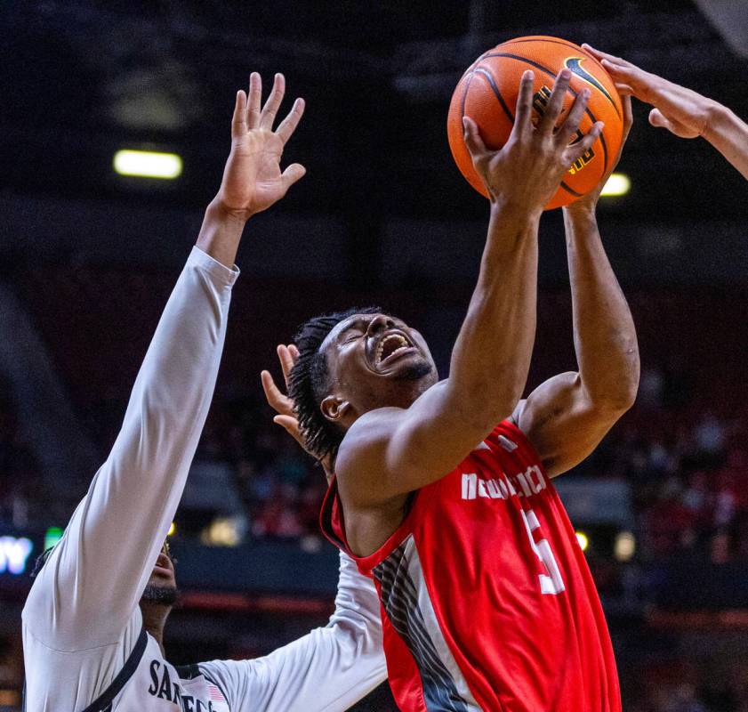 New Mexico Lobos guard Jamal Mashburn Jr. (5) has the ball slapped at as he elevates to shoot a ...