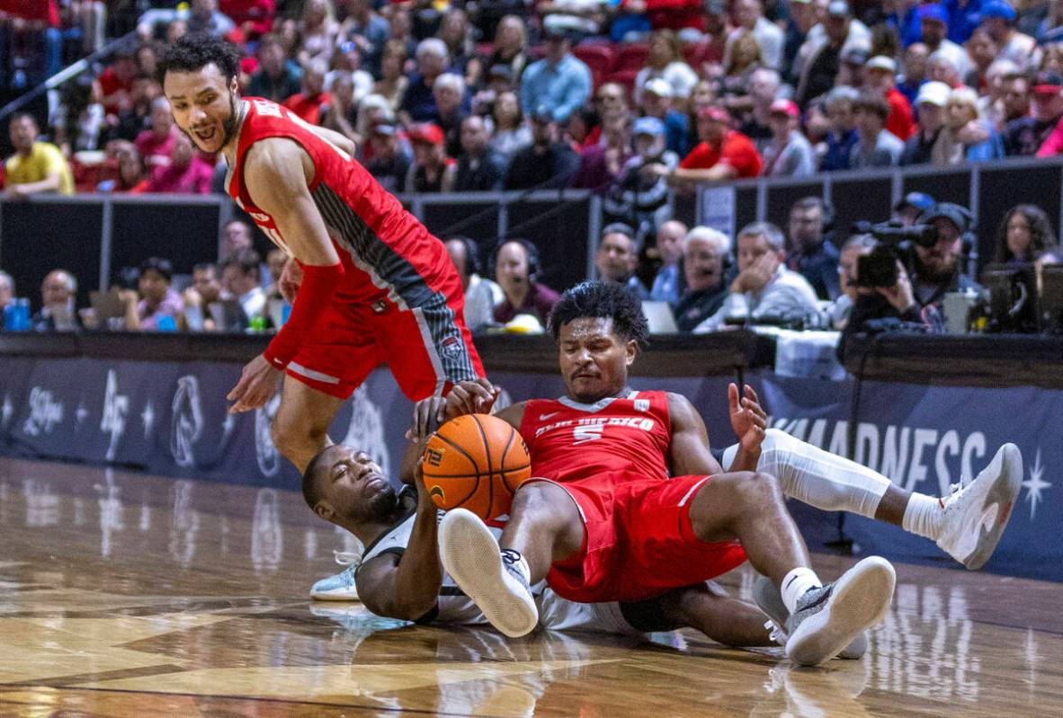 New Mexico Lobos guard Jamal Mashburn Jr. (5) lays atop of San Diego State Aztecs guard Darrion ...