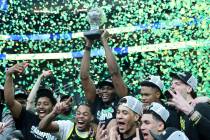 The Oregon Ducks celebrate after winning the championship game in the men's Pac-12 Tournament a ...