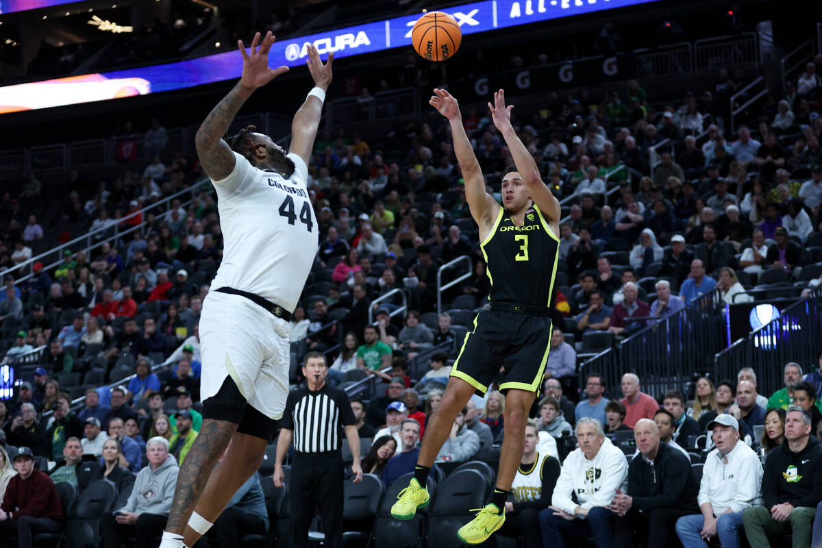 Oregon Ducks guard Jackson Shelstad (3) shoots against Colorado Buffaloes center Eddie Lampkin ...