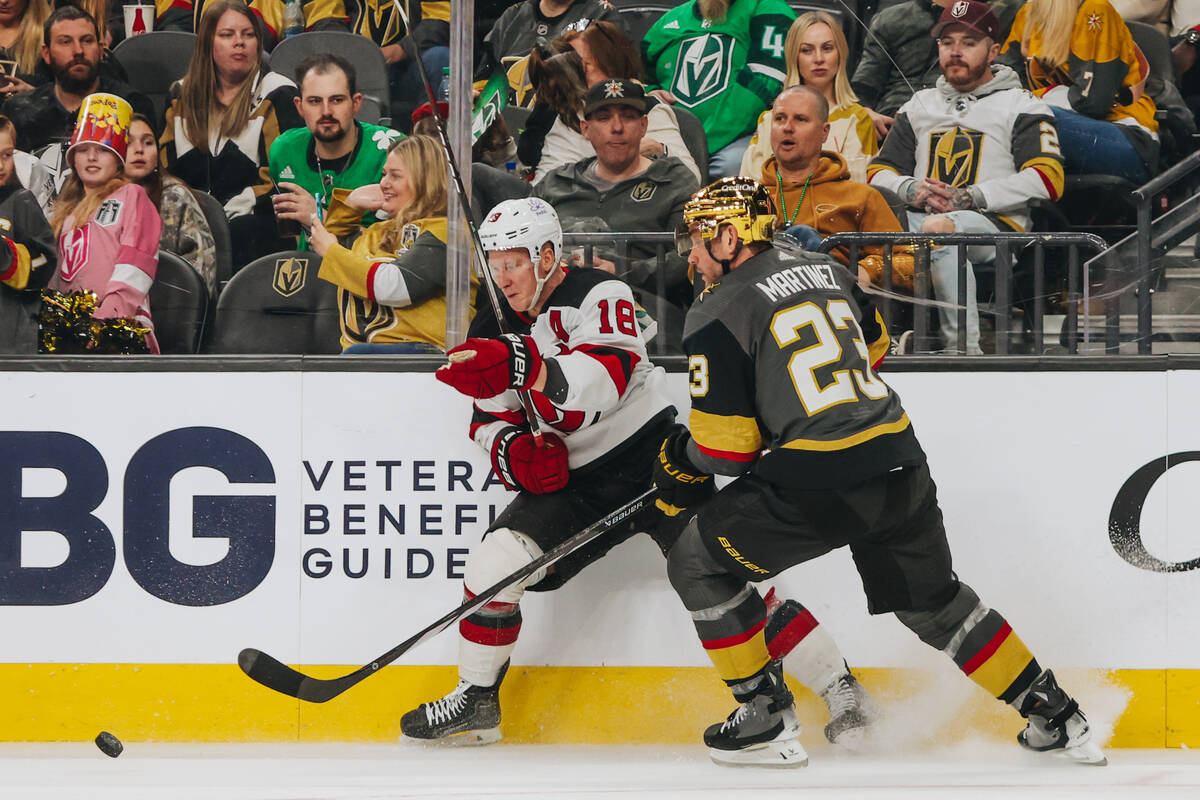 New Jersey Devils left wing Ondrej Palat (18) and Golden Knights defenseman Alec Martinez (23) ...