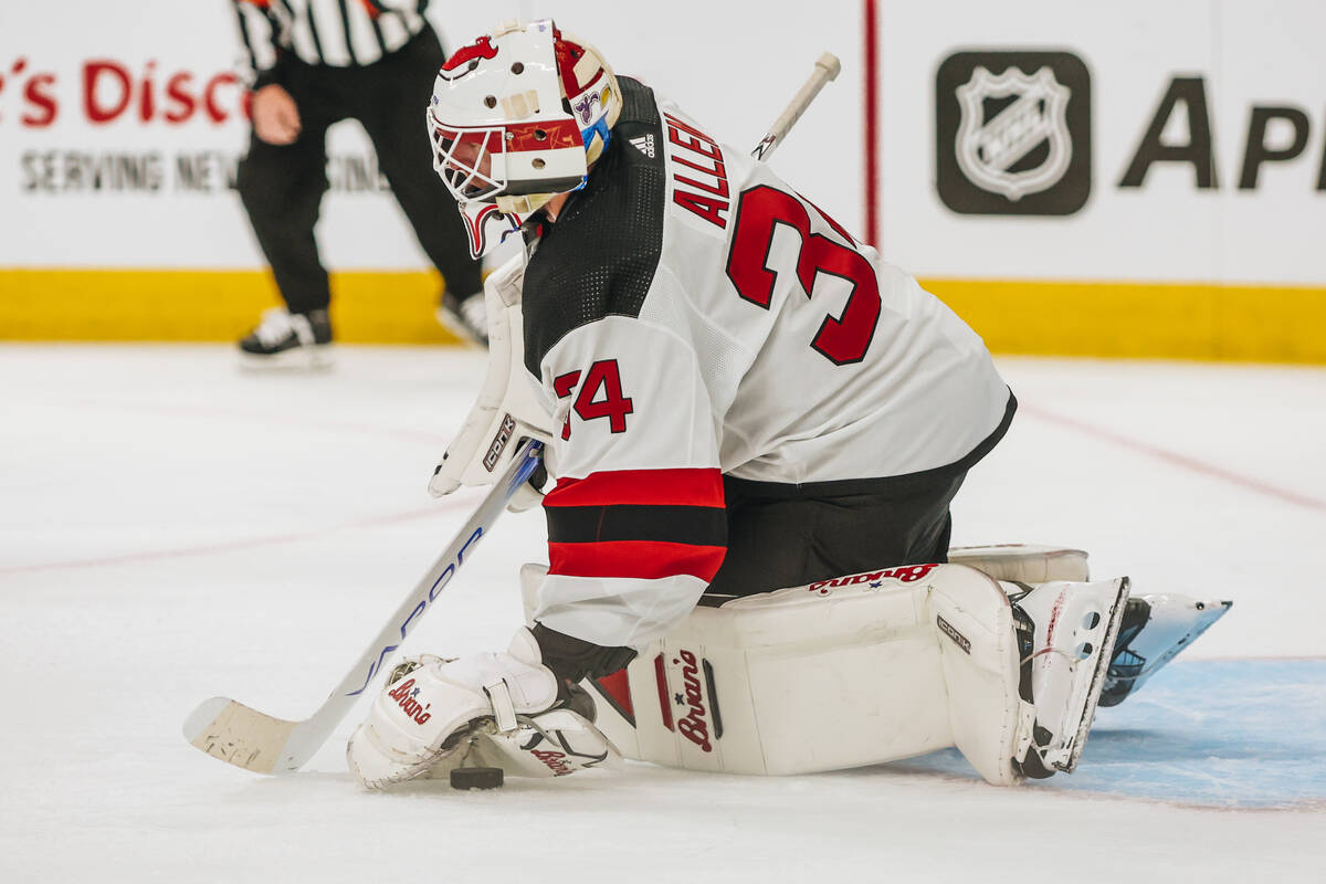 New Jersey Devils goaltender Jake Allen (34) makes a save during an NHL game between the Golden ...