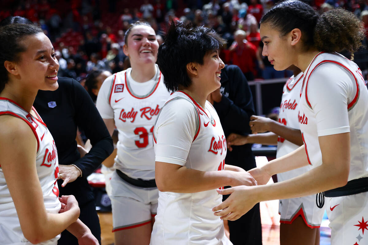 The UNLV Lady Rebels celebrate after winning an NCAA college basketball championship game again ...