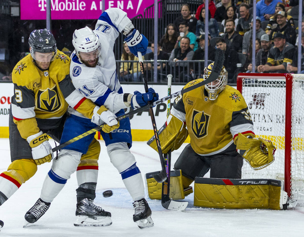 Golden Knights defenseman Brayden McNabb (3) and Tampa Bay Lightning center Luke Glendening (11 ...