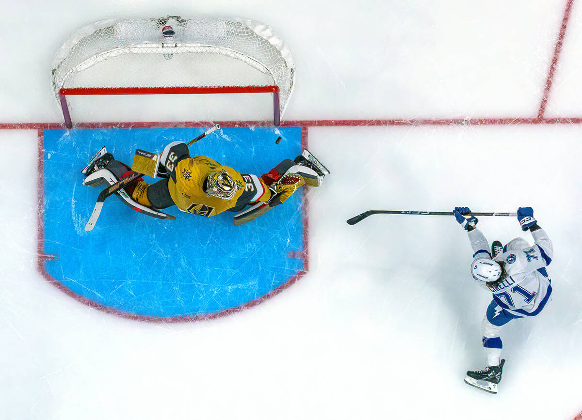 Golden Knights goaltender Adin Hill (33) is unable to stop a score by Tampa Bay Lightning cente ...