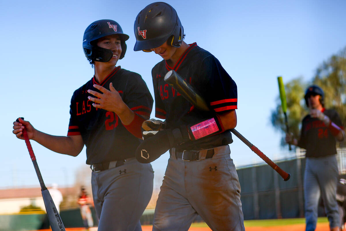 Las Vegas’ Dallas Martinez, left, and Mickey Martinez celebrate a run during a high scho ...