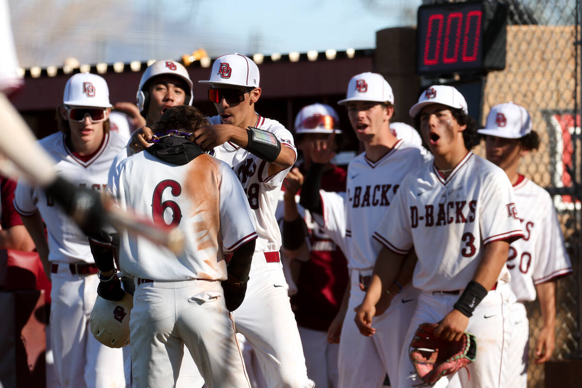 Desert Oasis celebrates after Ryan Martin (6) scored a run during a high school baseball game a ...