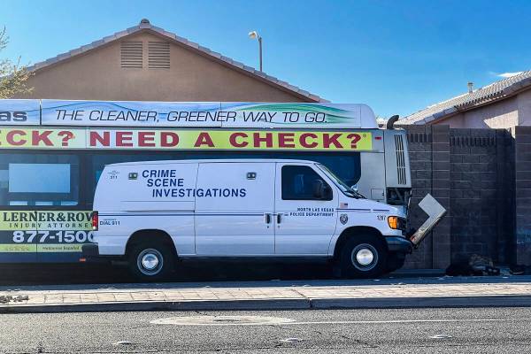 A North Las Vegas Police Department crime scene investigation van is parked next to an RTC bus ...