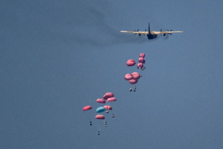 An aircraft airdrops humanitarian aid over northern Gaza Strip, as seen from southern Israel, W ...