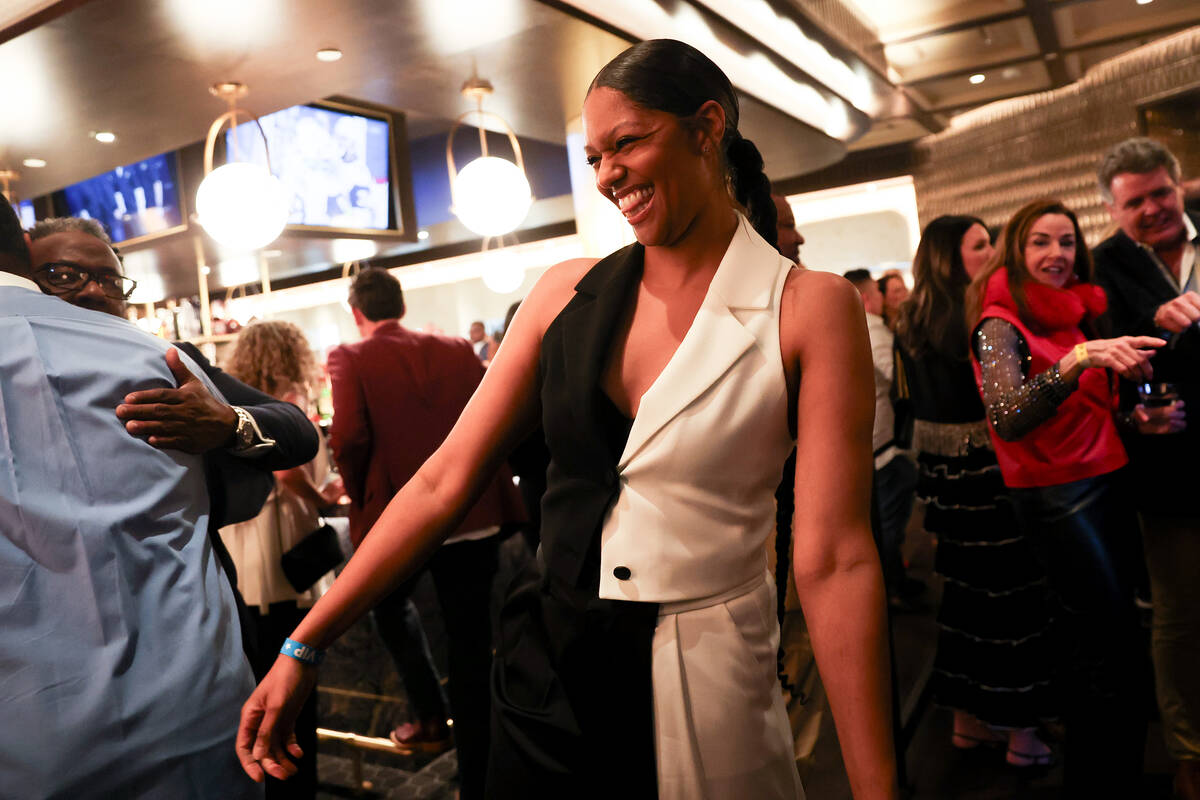 Partygoers greet one another during an opening night celebration at Emmitt's Vegas in Fashion S ...