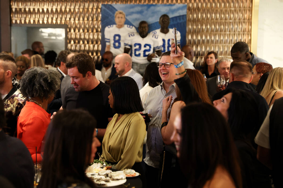 Attendees mingle during an opening night party at Emmitt's Vegas in Fashion Show mall on Thursd ...