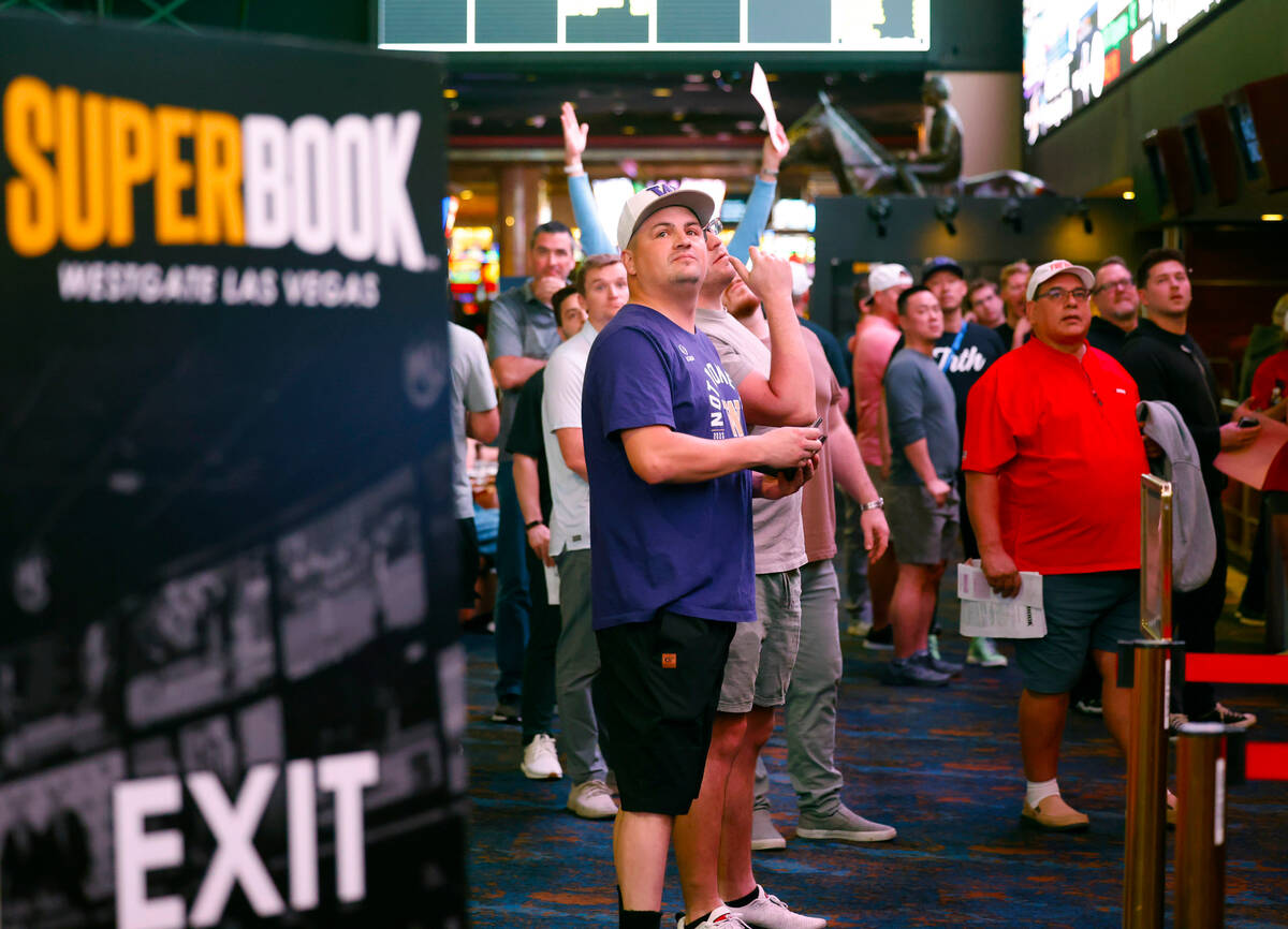 People wait in line to bet on the NCAA basketball tournament at Westgate sports book, on Thursd ...