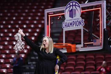 UNLV Lady Rebels head coach Lindy La Rocque cuts the net after her team won an NCAA college bas ...