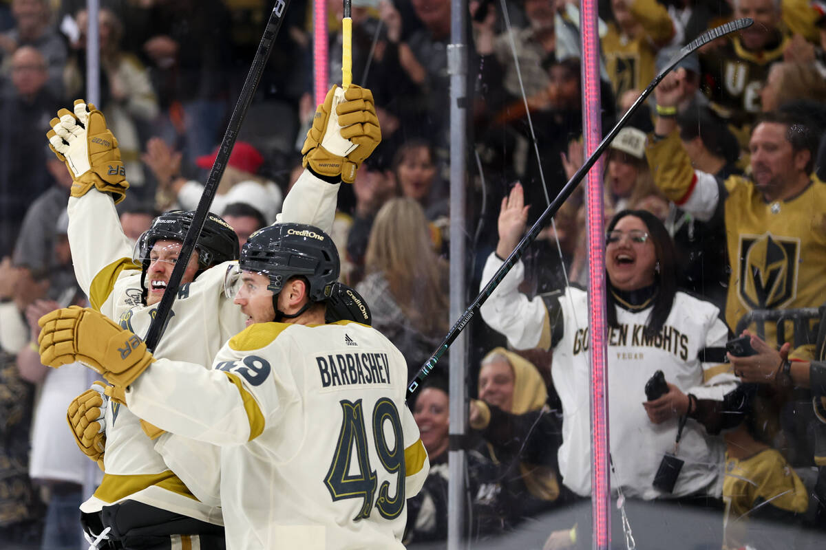 Golden Knights center Jack Eichel, left, celebrates his goal with center Ivan Barbashev (49) du ...