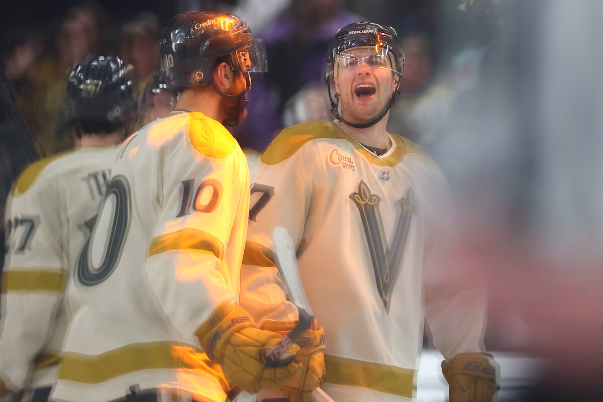 Golden Knights defenseman Ben Hutton (17) and center Nicolas Roy (10) celebrate after winning a ...