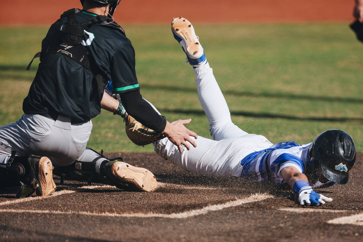 Basic outfielder Andruw Giles (29) tries to slide to home base but is out during a baseball gam ...