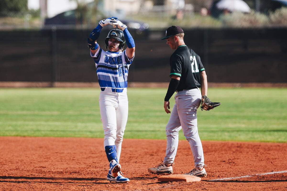 Basic outfielder Andruw Giles (29) signals to his teammates after making it to first base durin ...