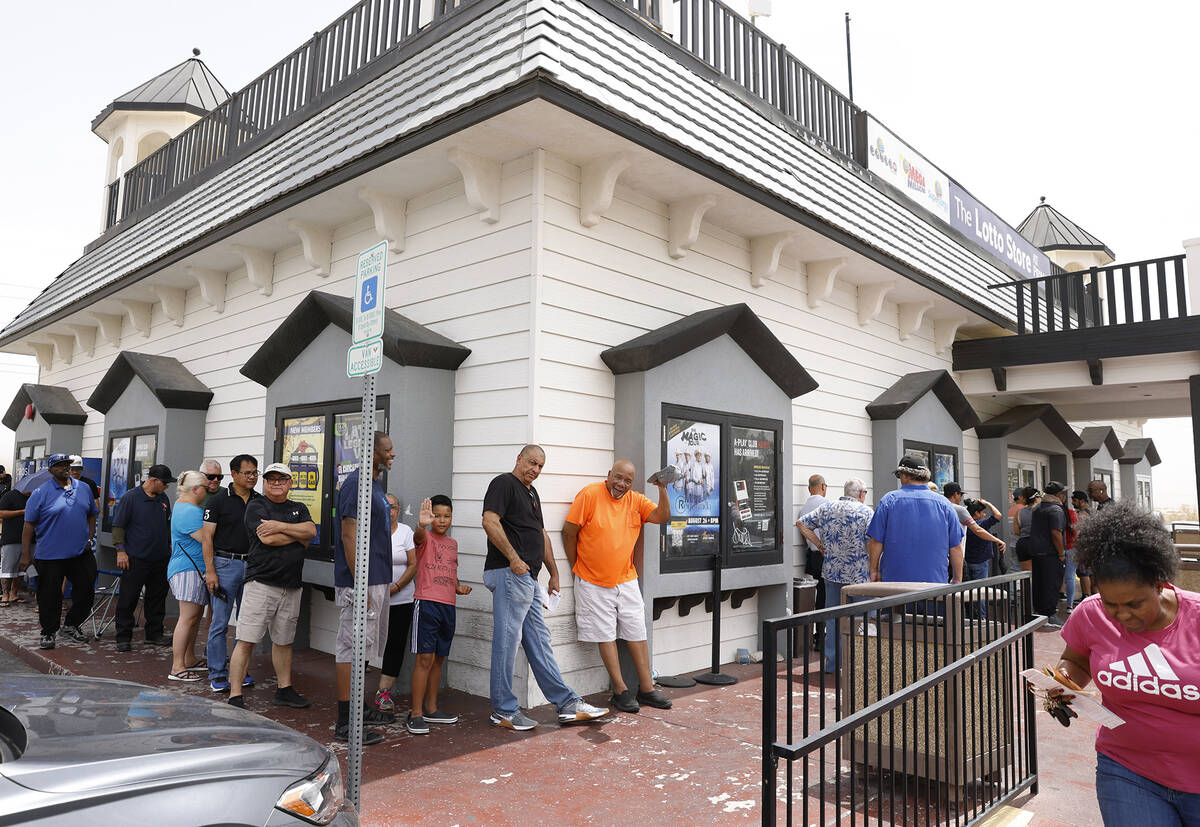 People line up outside of the Primm Valley Lotto Store to buy the Mega Million lottery tickets, ...