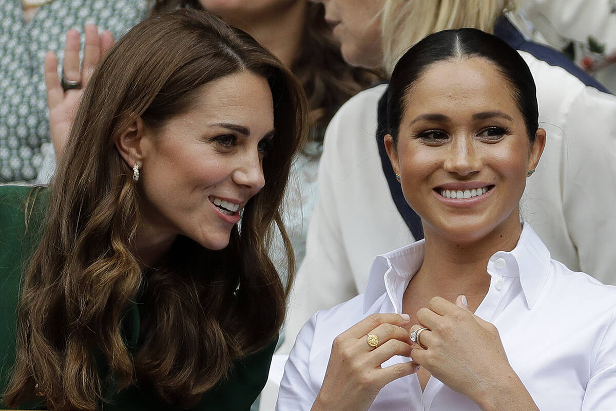 FILE - Britain's Kate, Duchess of Cambridge, left, and Meghan, Duchess of Sussex speak as they ...
