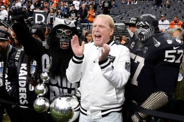 Raiders owner Mark Davis poses for a photo with fans prior to the start of an NFL football game ...