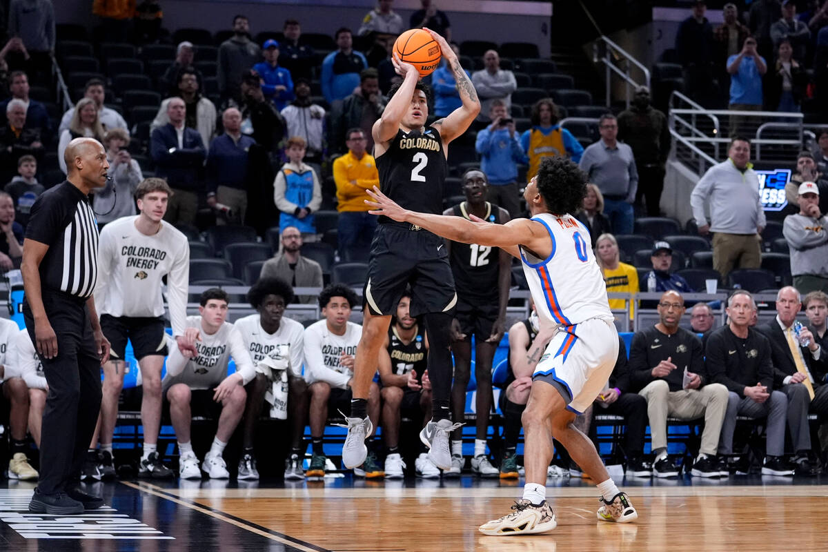 Colorado guard KJ Simpson (2) shoots over Florida guard Zyon Pullin (0) at the end of a first-r ...