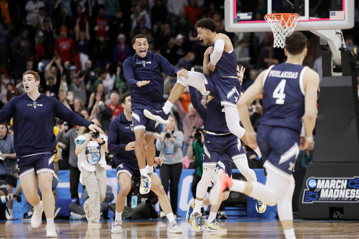 Yale players celebrate after their win over Auburn in a first-round college basketball game in ...