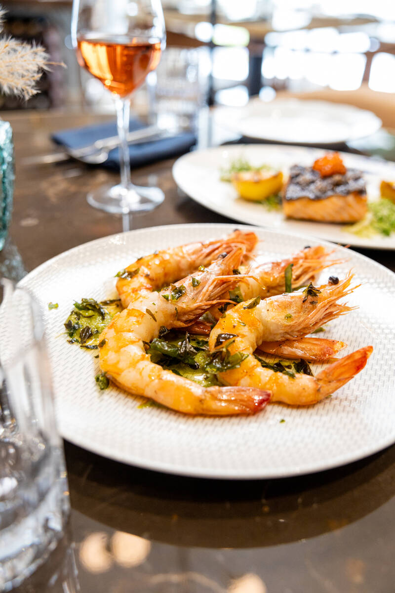Baked tiger prawns, front, and grilled Ora king salmon from the spring 2024 menu at La Strega i ...