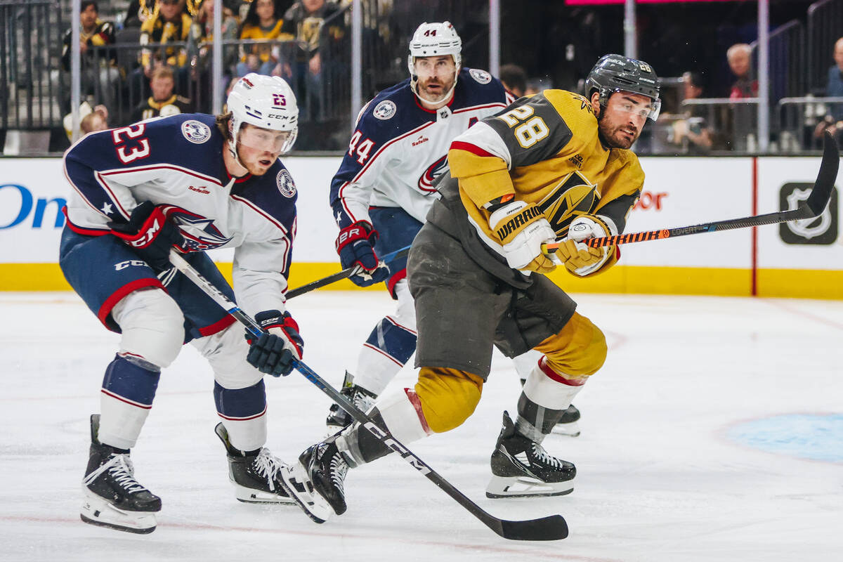 Golden Knights left wing William Carrier (28) races to beat Columbus Blue Jackets defenseman Ja ...