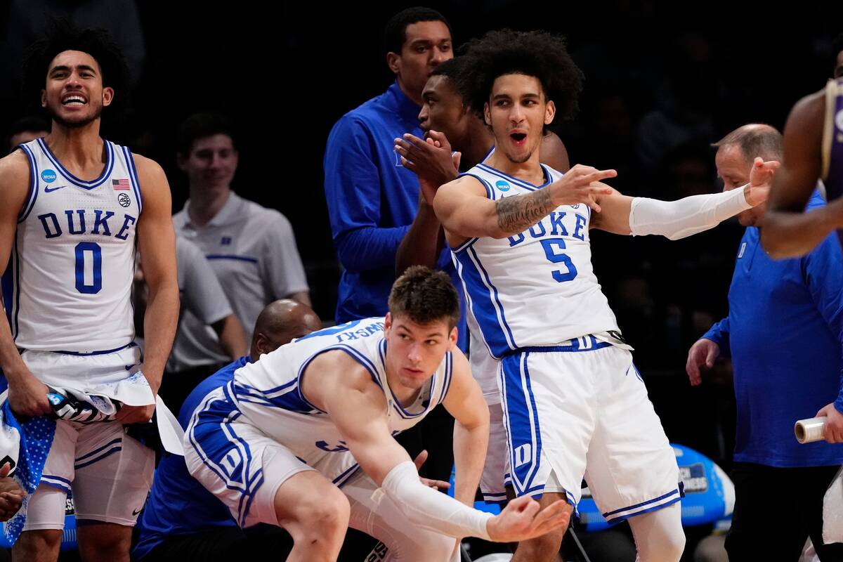 Duke's Jared McCain (0), Kyle Filipowski and Tyrese Proctor (5) gesture to teammates during the ...