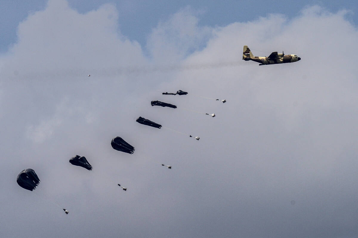 An aircraft airdrops humanitarian aid over the northern Gaza Strip, as seen from southern Israe ...