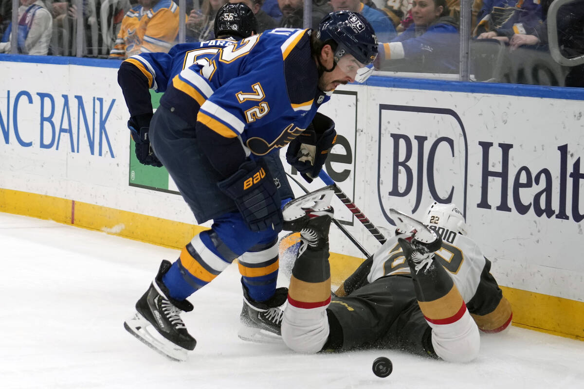 Vegas Golden Knights' Michael Amadio (22) falls as St. Louis Blues' Justin Faulk (72) reaches f ...