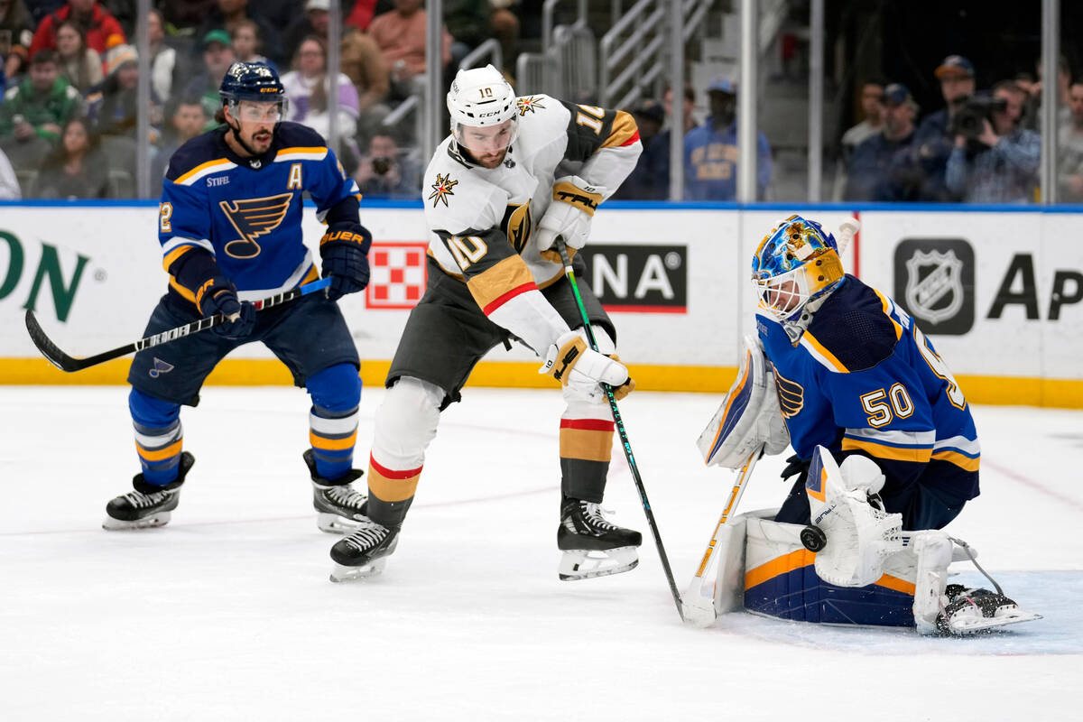 St. Louis Blues goaltender Jordan Binnington (50) deflects a shot by Vegas Golden Knights' Nico ...