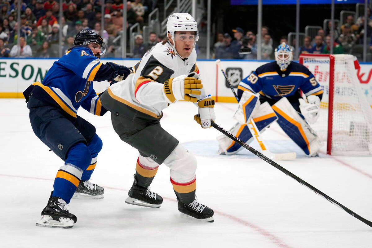 Vegas Golden Knights' Zach Whitecloud (2) reaches for a puck as St. Louis Blues goaltender Jord ...