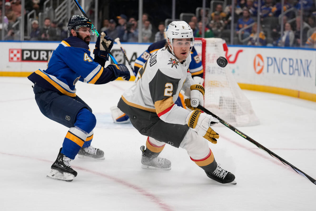 Vegas Golden Knights' Zach Whitecloud (2) reaches for a puck as St. Louis Blues Nick Leddy (4) ...