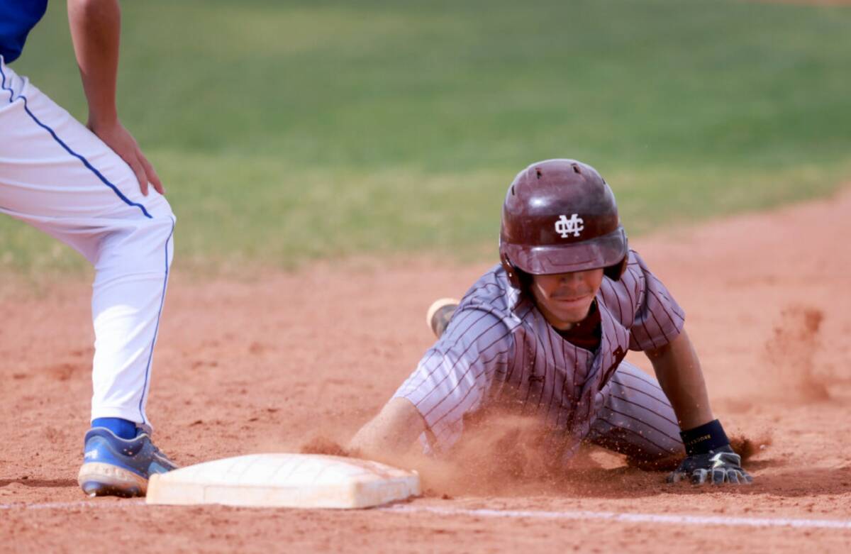 Cimarron-Memorial baserunner Kai Mares (7) dives back to first during a pickoff attempt by Sier ...