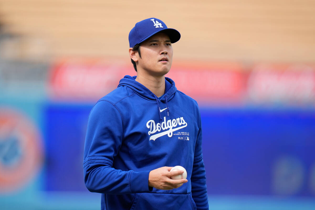 Los Angeles Dodgers' Shohei Ohtani stands on the field during warmups before the team's spring ...